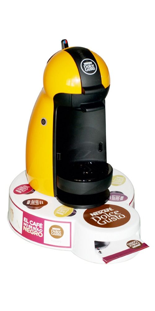 Una máquina Nespresso amarilla está encima de una mesa blanca.