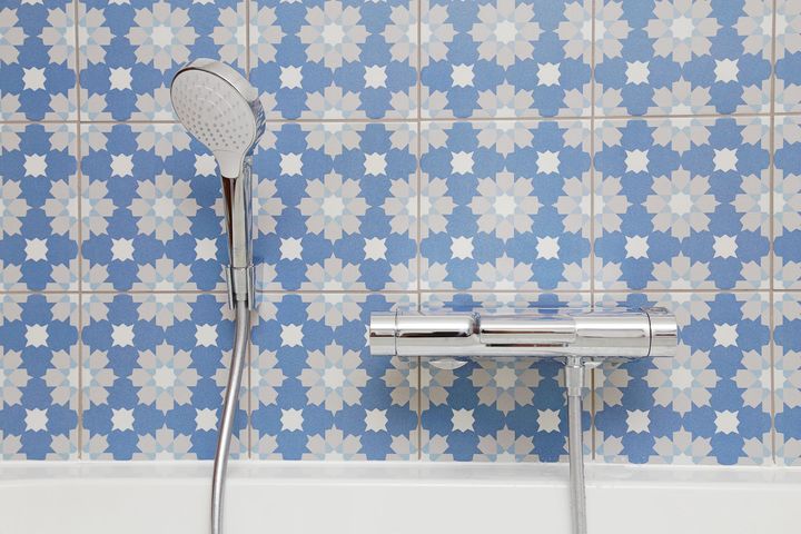 De la faïence bleue et un pommeau de douche.