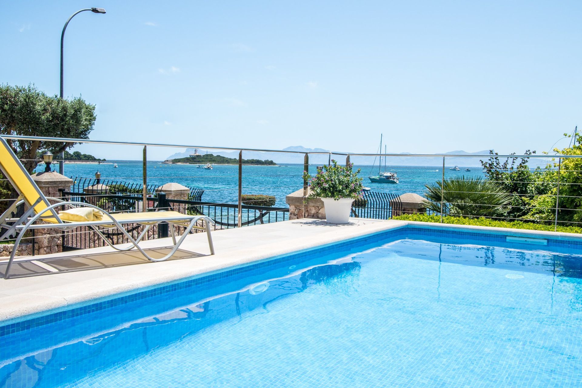 A large swimming pool with a view of the ocean.