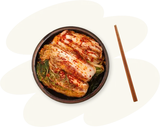 A bowl of food with chopsticks in it on a white background.