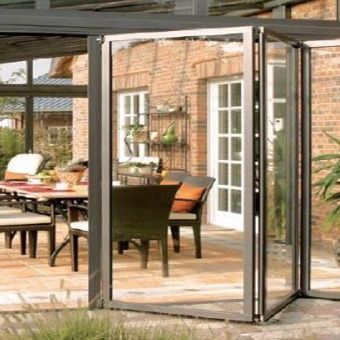 Un patio con una mesa y sillas frente a un edificio de ladrillo.