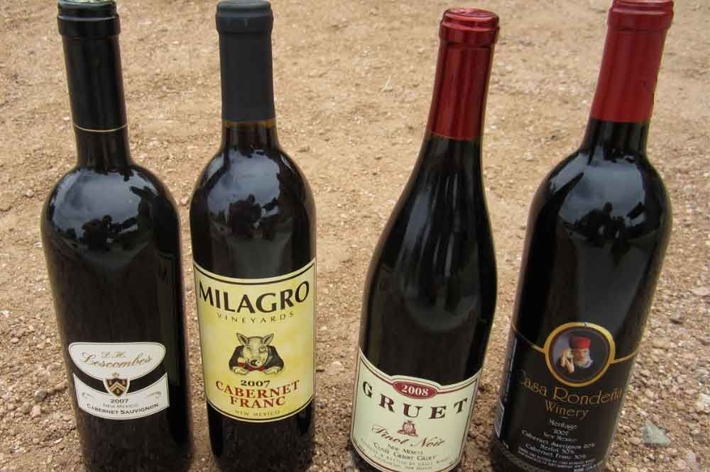 various wine bottles sitting on the ground