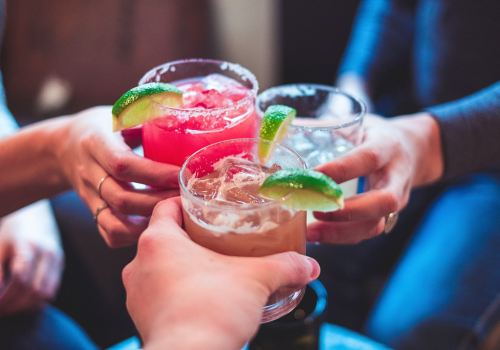 Group of people enjoying margarita glasses
