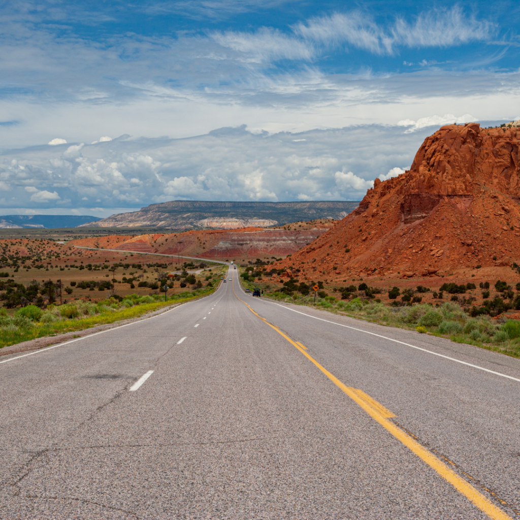 Open road carving through the Mountains in New Mexico