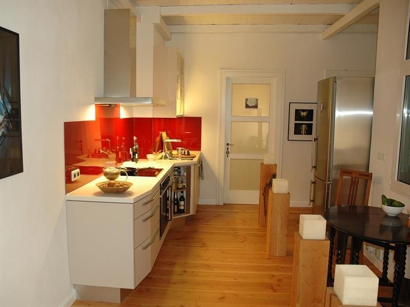 Eine Küche mit weißen Schränken und Geräten aus Edelstahl