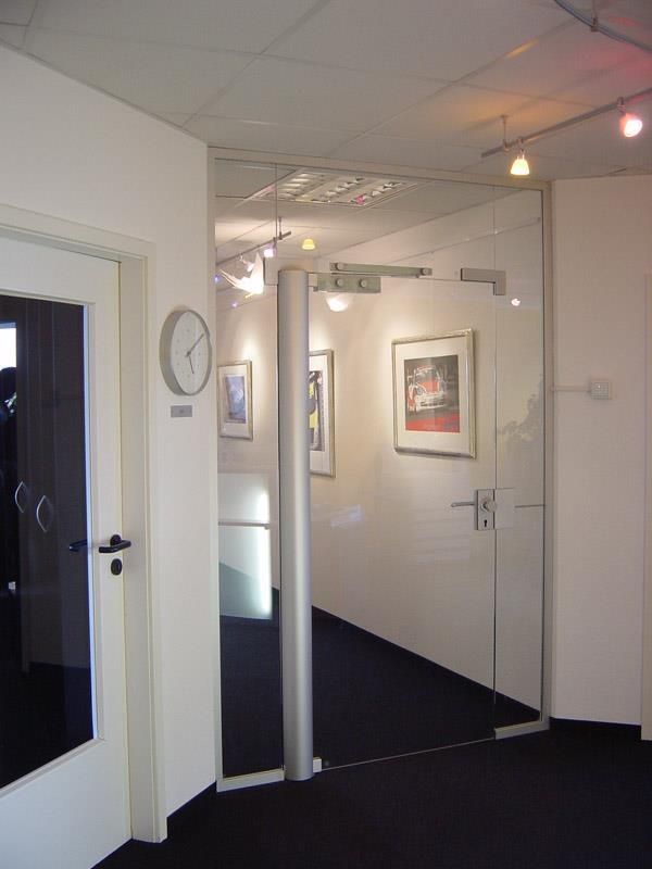 Ein Flur mit einer Glastür und einer Uhr an der Wand