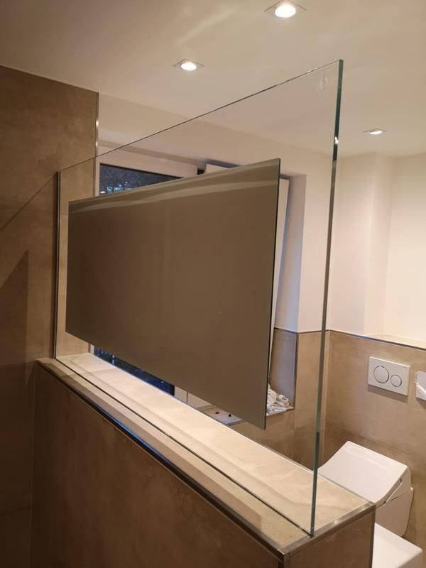 Ein Badezimmer mit Glasgeländer und Toilette.