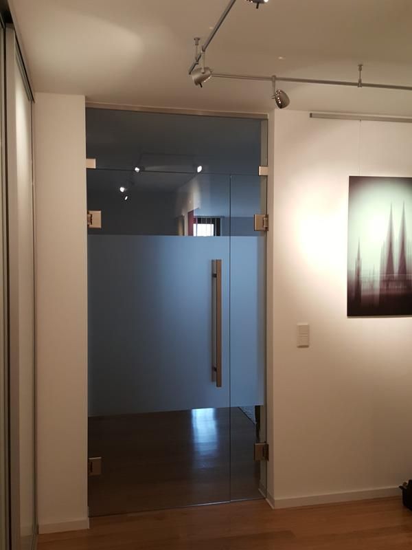 Ein Raum mit einer Glastür und einem Bild an der Wand