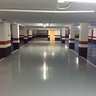 Un estacionamiento con muchas columnas y una puerta amarilla.