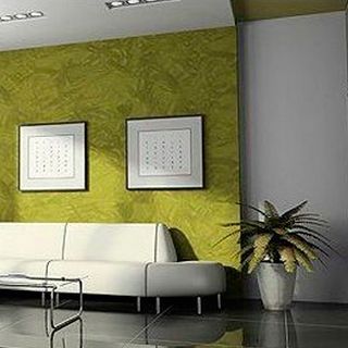 Una sala de estar con un sofá, una mesa y una planta en maceta.