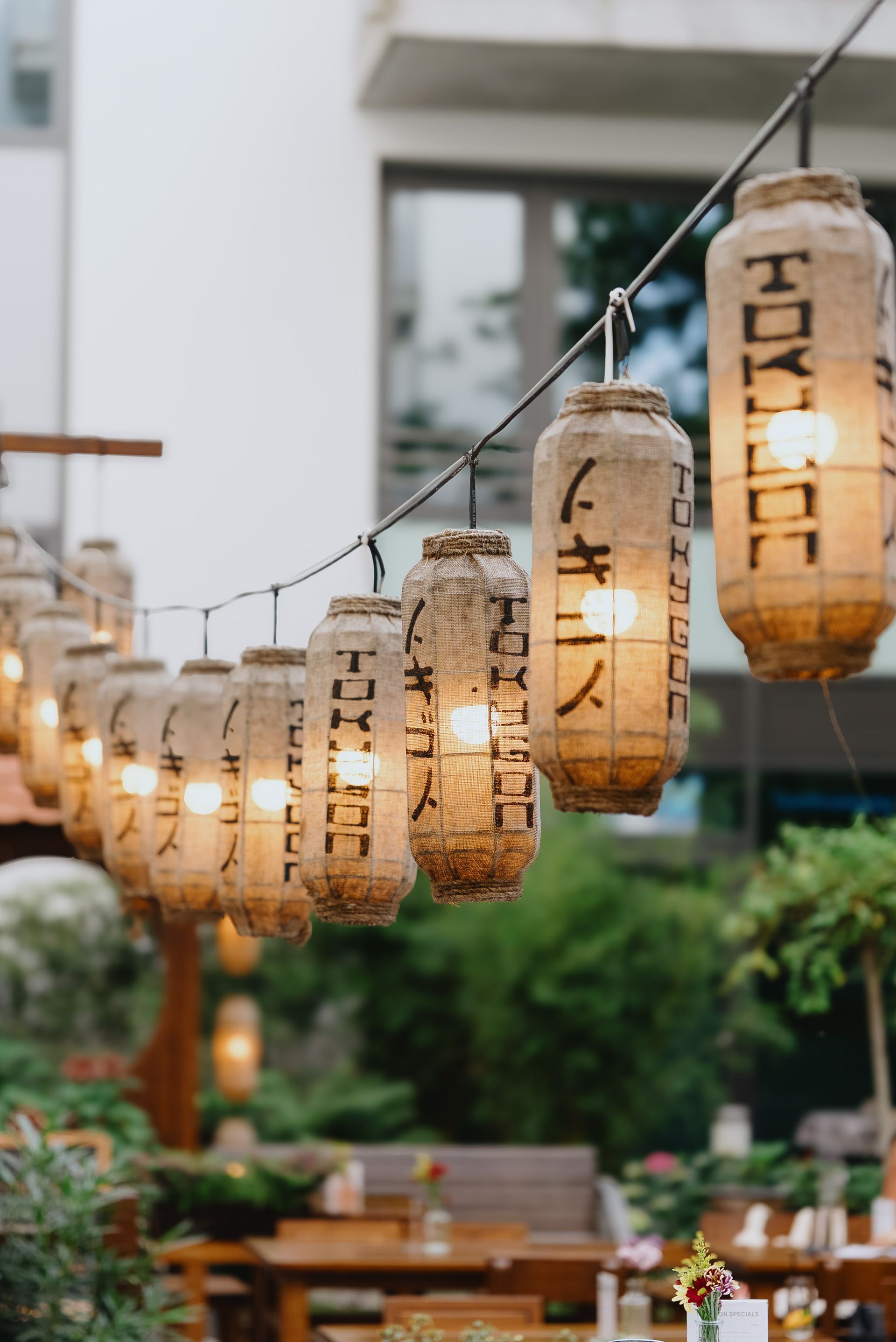 Restaurantinterieur im japanischen Stil mit Holztischen, dekorativen Fenstern.