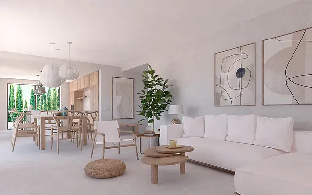 Una sala de estar con un sofá blanco y una mesa de madera.