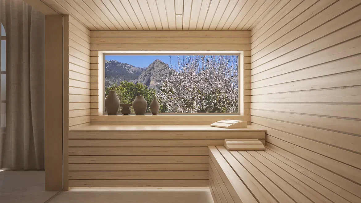 Una sauna de madera con ventana y vistas a las montañas.