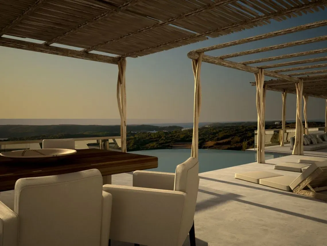Una mesa y sillas debajo de una pérgola con vista a una piscina.