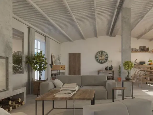 Una sala de estar con sofá, mesa, chimenea y reloj en la pared.