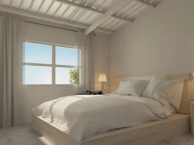 Un dormitorio con una cama grande y una ventana.