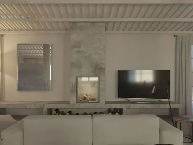 Una sala de estar con sofá, chimenea, televisión y espejo.