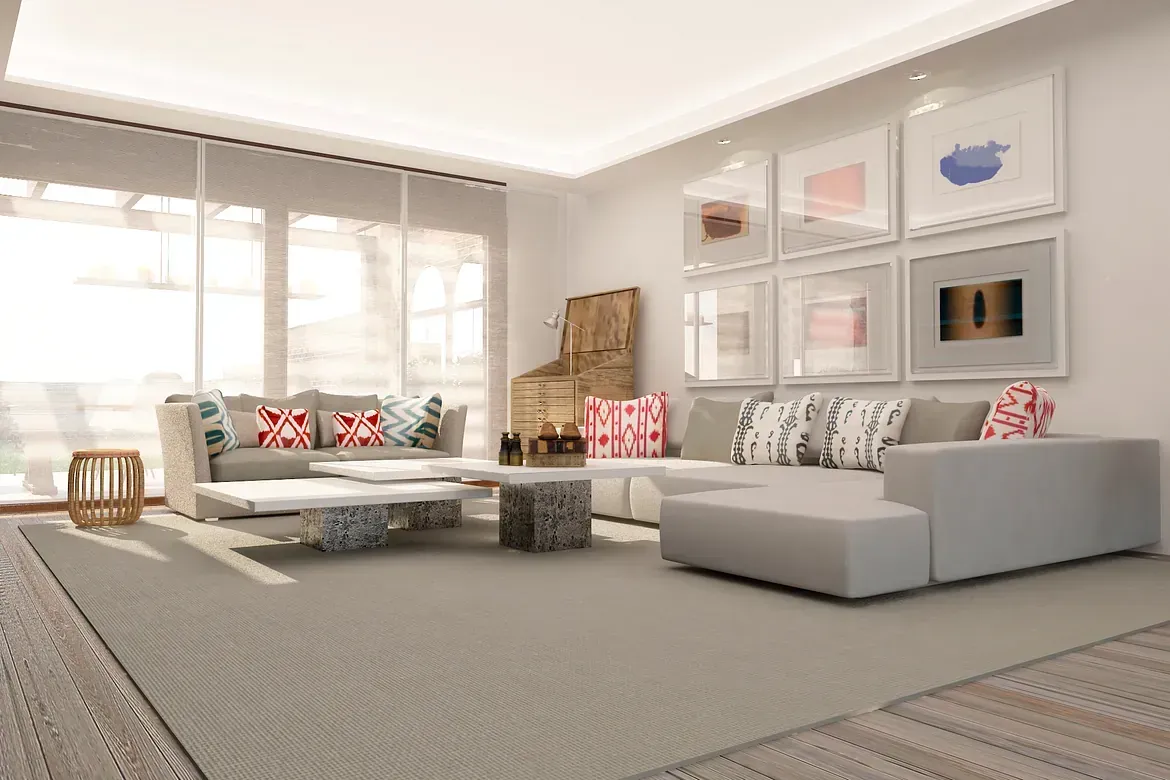 Una sala de estar con un sofá, una mesa de café y cuadros en la pared.