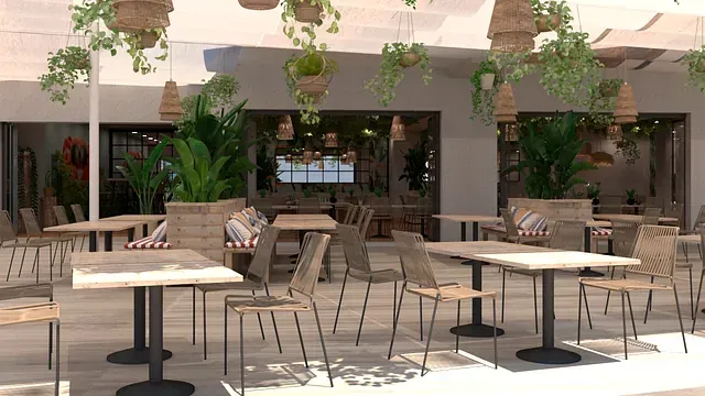 Un restaurante con mesas y sillas y plantas colgando del techo.