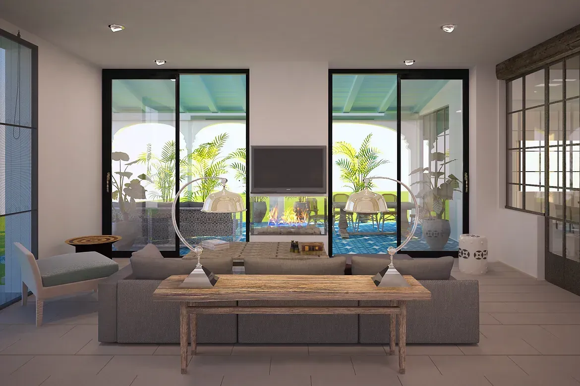 Una sala de estar con sofá, mesa, televisión y puertas corredizas de vidrio.