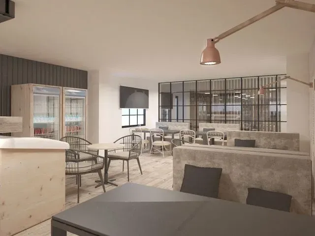 Impresión artística de un restaurante con mesas y sillas.