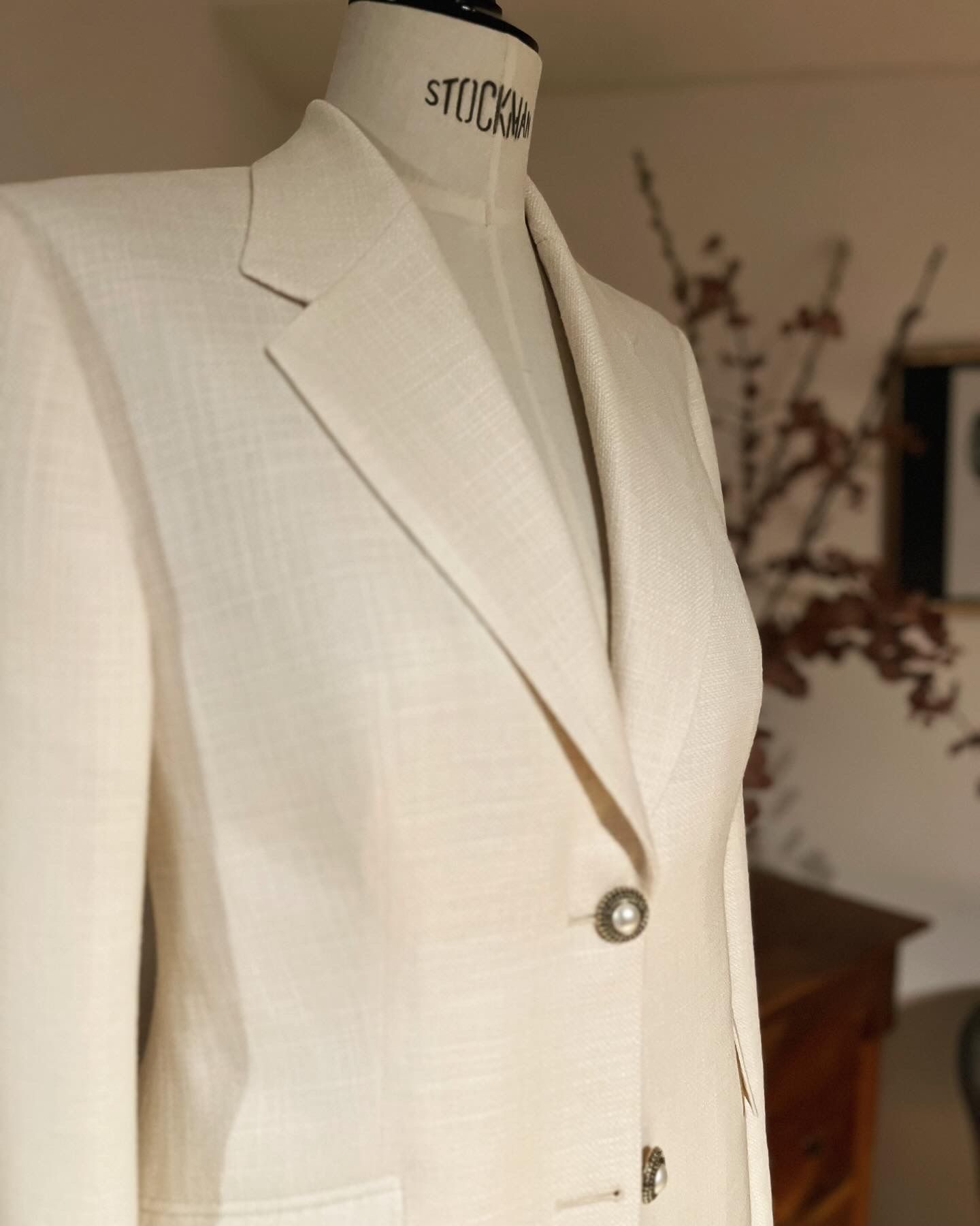 Cremefarbener Blazer an einer Schneiderpuppe in einem Studio-Setting