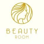 Logotipo dorado de l&iacute;neas que representa un perfil facial estilizado rodeado de cabello dentro de un c&iacute;rculo, sobre el texto "BEAUTY ROOM".