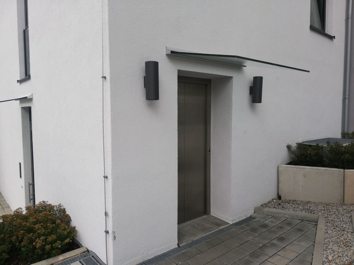 Überdachung eines Einganges aus Metall und Glas