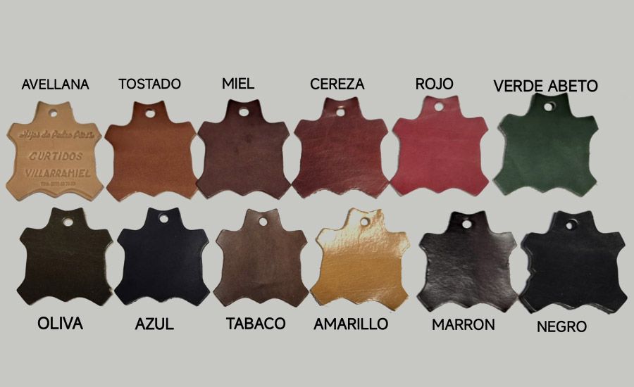 Color chart of 12 leather-like swatches labeled in Spanish: avellana, tostado, mel, cereza, rojo, verde abeto, oliva, azul, tabaco, amarillo, marrón, negro