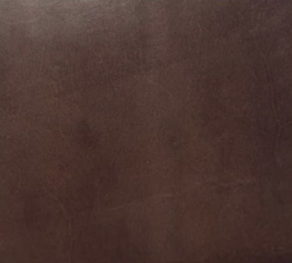 Primer plano de una superficie marrón borrosa con textura tenue y sin objetos definidos.