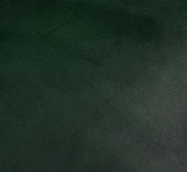 Superficie borrosa de color verde oscuro con una sombra gris en la esquina inferior derecha.