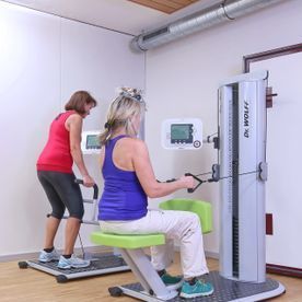 Patientinnen trainieren an Geräten