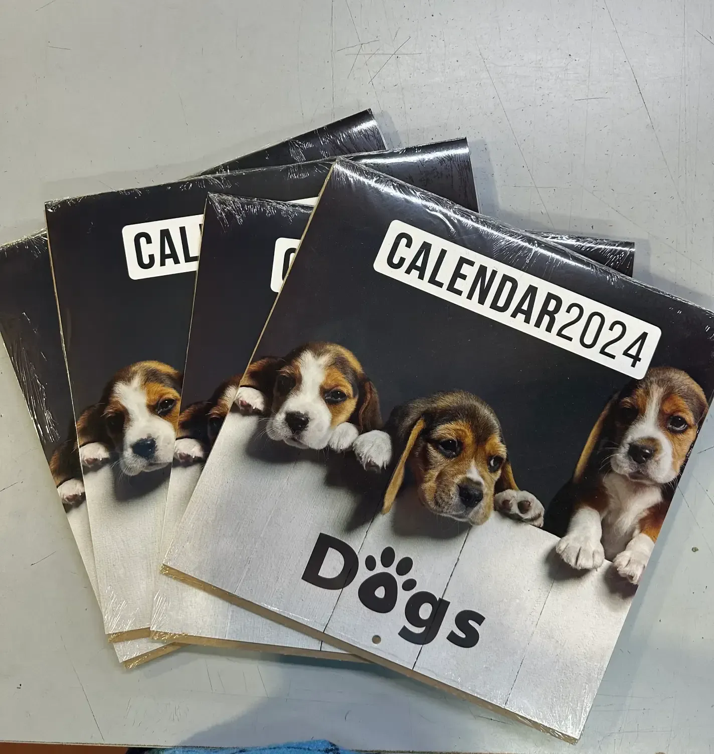 Cuatro calendarios con perros están apilados uno encima del otro.