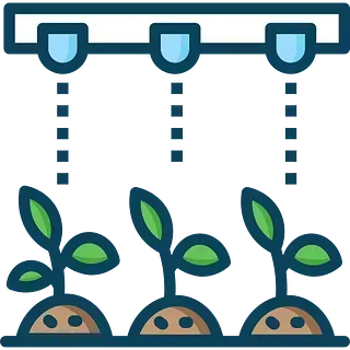 Tres plantas crecen del suelo bajo una luz.
