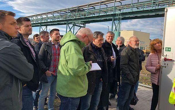 Eine Gruppe von Menschen steht vor einem Gebäude.