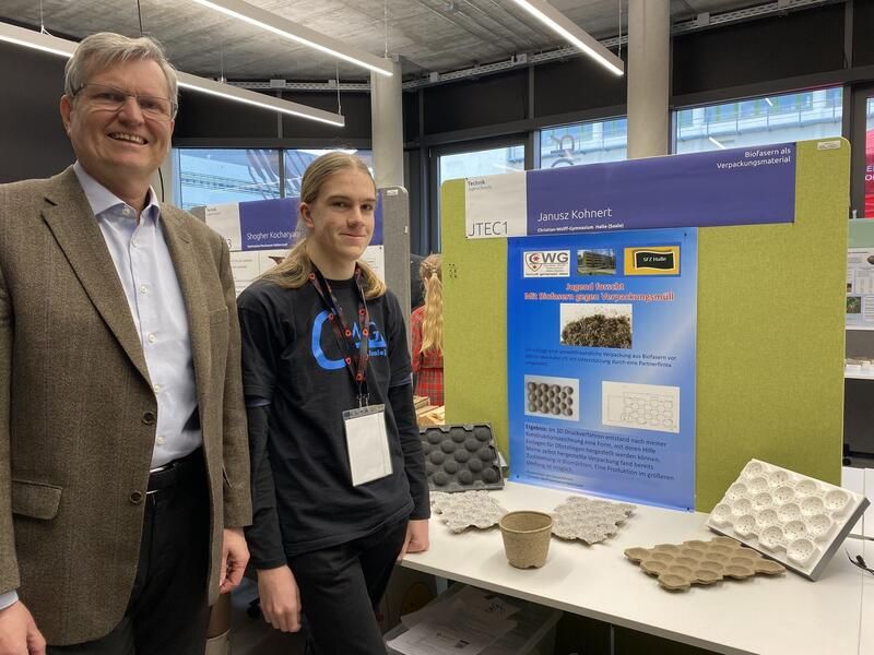Ein Mann und eine Frau stehen nebeneinander vor einem Tisch.