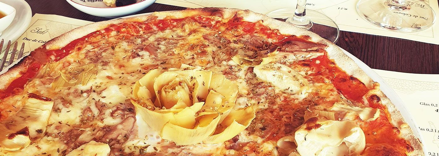 Eine Pizza mit einer Rose darauf auf einem Tisch