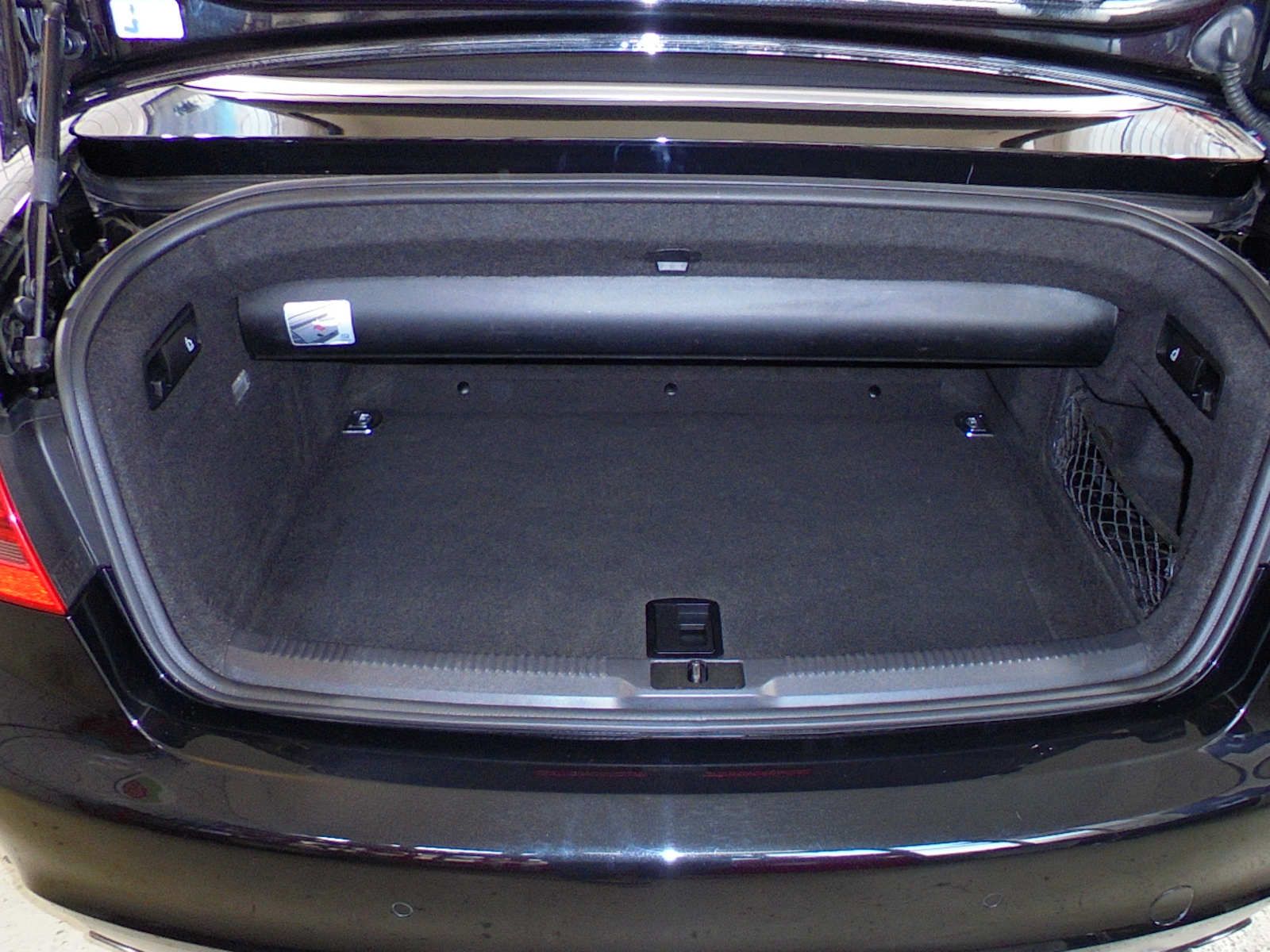 Der Kofferraum eines schwarzen Autos ist offen und leer