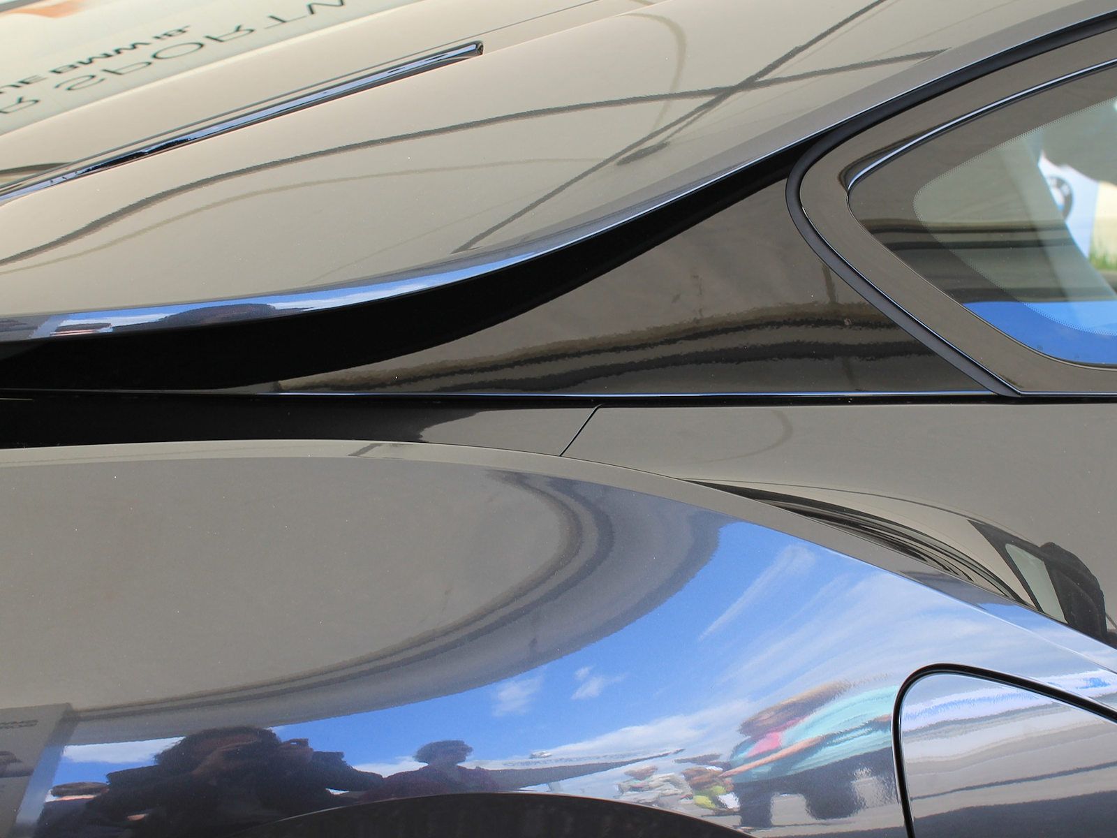 Eine Nahaufnahme eines Autos mit einem blauen Himmel, der sich in der Windschutzscheibe spiegelt