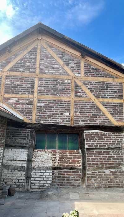 Ein Backsteingebäude mit Holzrahmen und Fenster.
