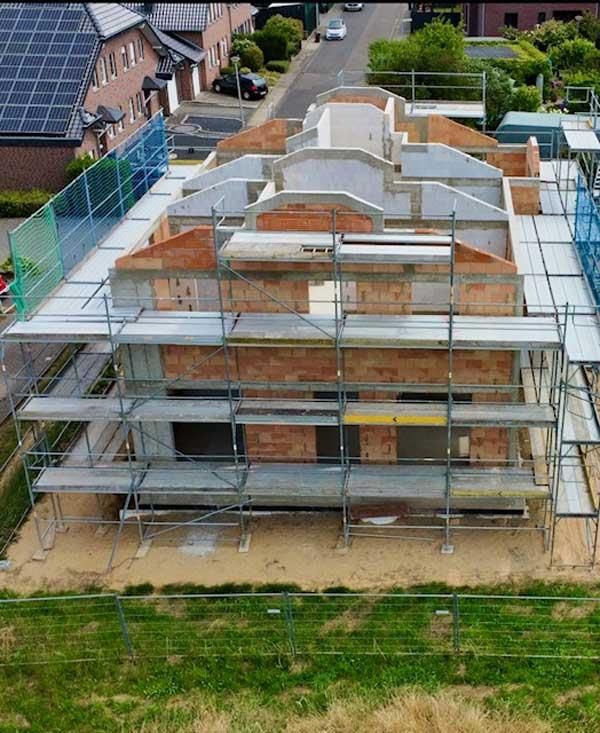 Eine Luftaufnahme eines im Bau befindlichen Gebäudes, das von einem Gerüst umgeben ist.