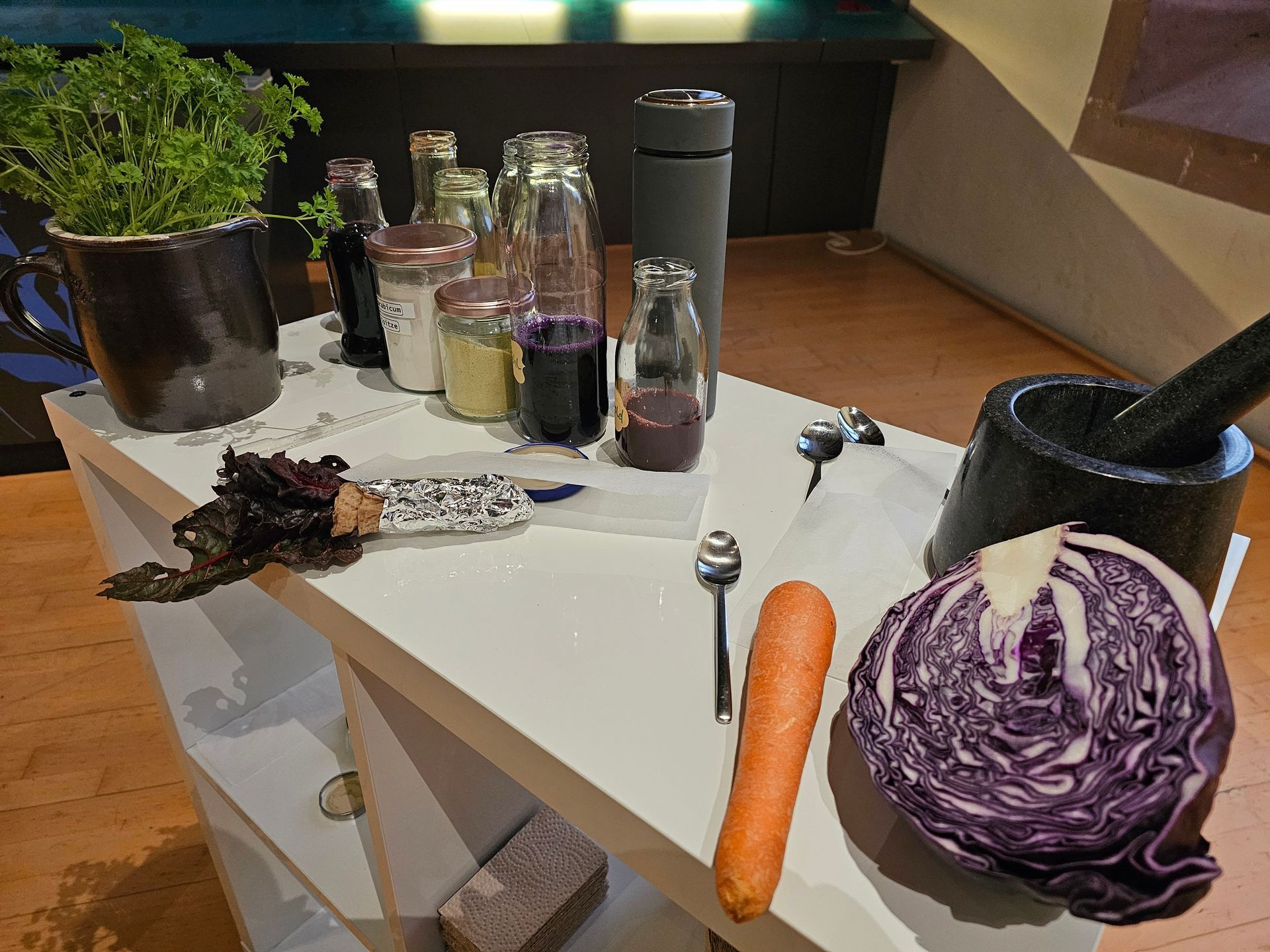 Ein Tisch mit einem Haufen Gemüse und Flaschen darauf