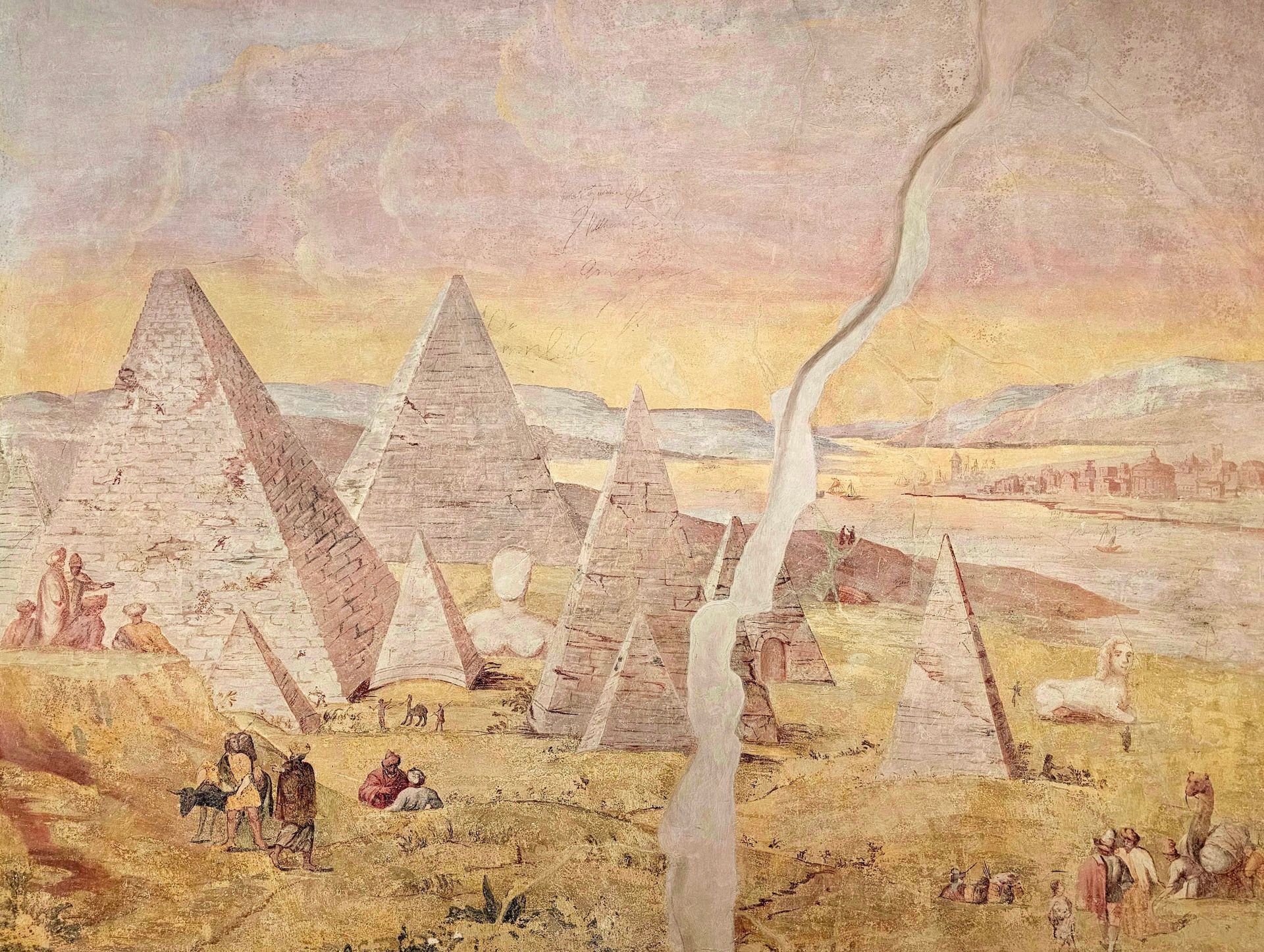 Ein Gemälde einer Gruppe von Menschen auf einem Feld mit Pyramiden im Hintergrund.
