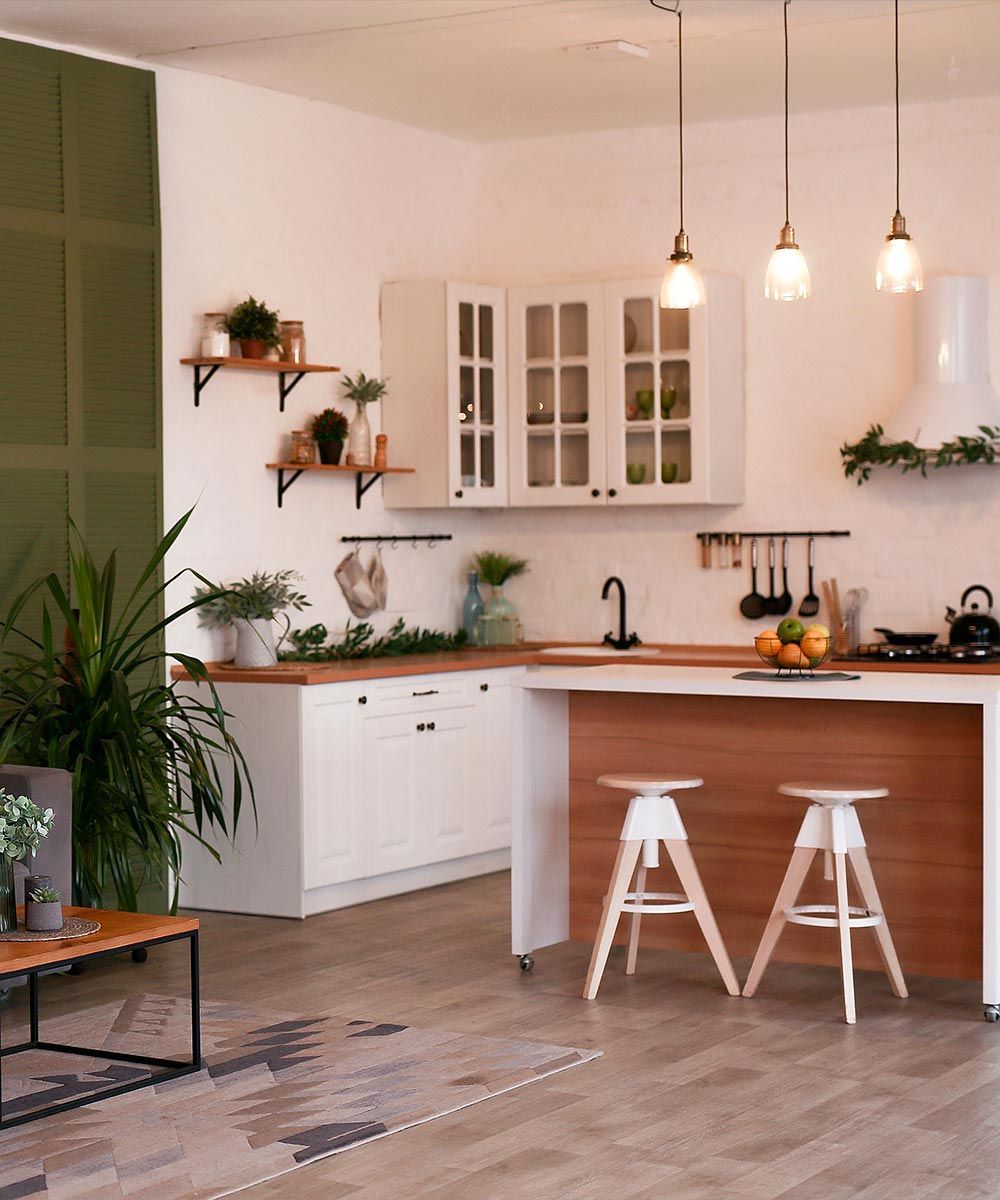 Una cocina con una isla de madera y dos taburetes.