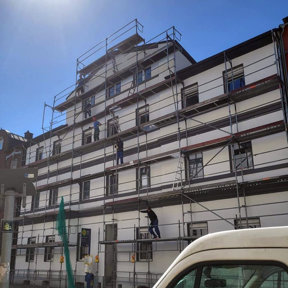 Ein weißer Lieferwagen steht vor einem im Bau befindlichen Gebäude, Tool Time NRW GmbH