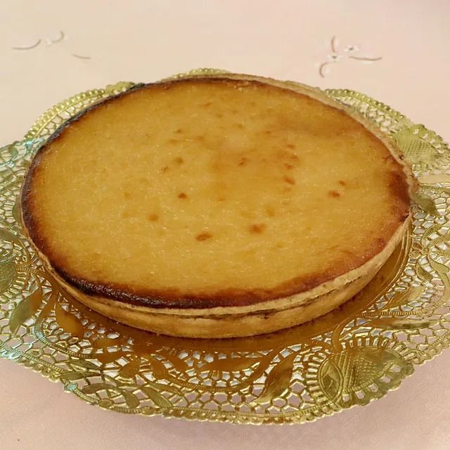 Un pastel está sobre un plato dorado en una mesa.