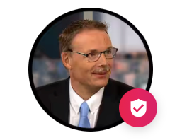 Portrait of a man in a suit and glasses with a pink shield badge overlay