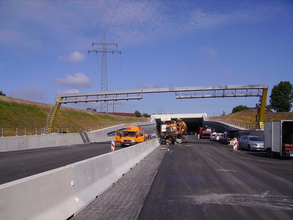 Eine Baustelle auf einer Autobahn mit einem Tunnel im Hintergrund