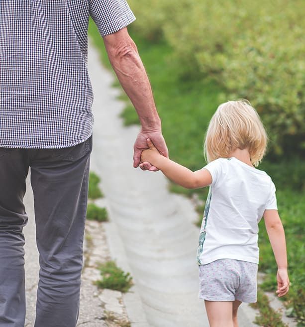 Grand-père tenant sa petite fille par la main