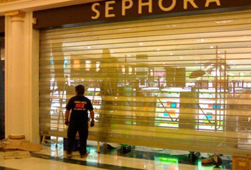Un hombre está parado frente a una tienda Sephora.